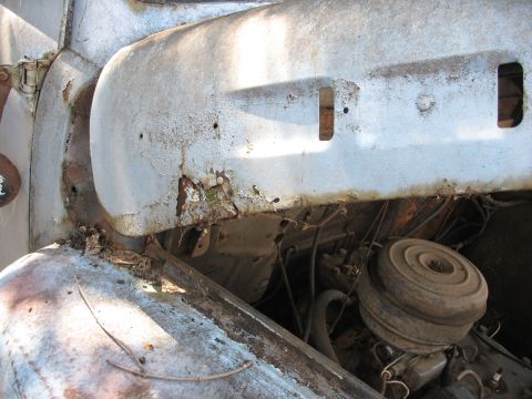 1952 Ford Panel Van - Engine bay detail of a weathered truck, showing rust and an air cleaner.