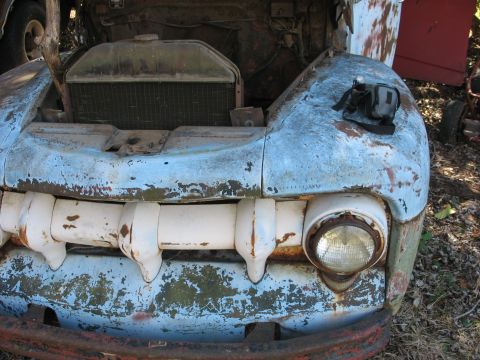 1952 Ford Panel Van - Front view of a weathered 1952 Ford Panel Van, showing its distinctive grille and headlight.