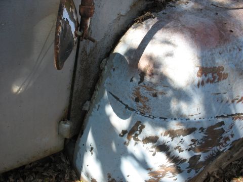 1952 Ford Panel Van - A partial view of a vehicle's exterior reveals signs of age and wear on its body panels.