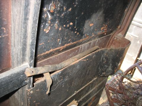 1952 Ford Panel Van - Interior view of a vehicle's engine bay, showing a latch and rusty metal components.