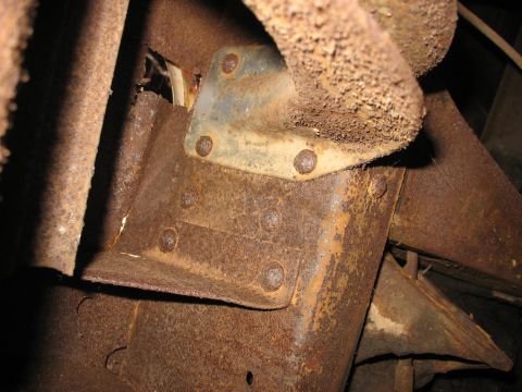 1952 Ford Panel Van - Close-up view of heavily rusted vehicle frame components, showing significant corrosion and wear.