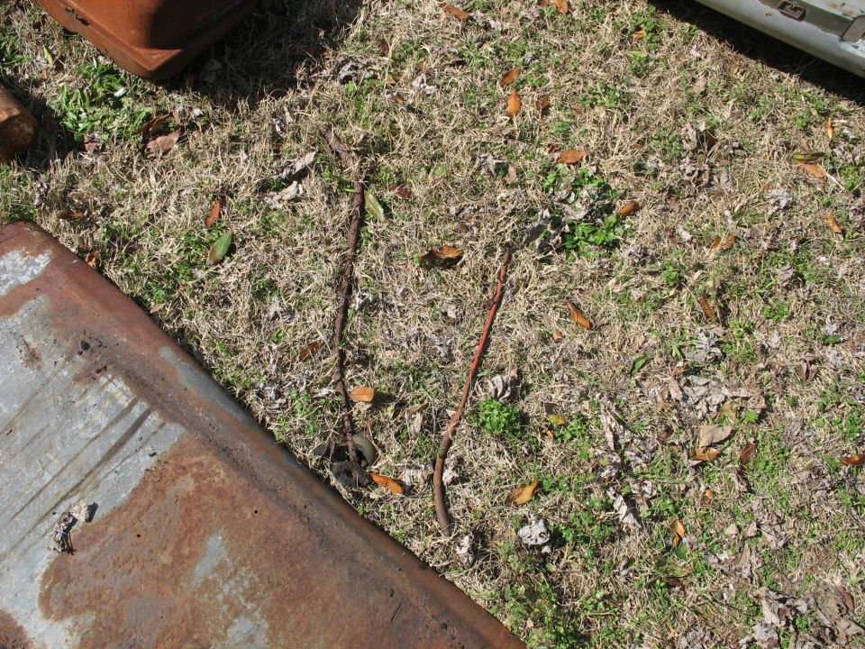 Rusty metal parts on grass