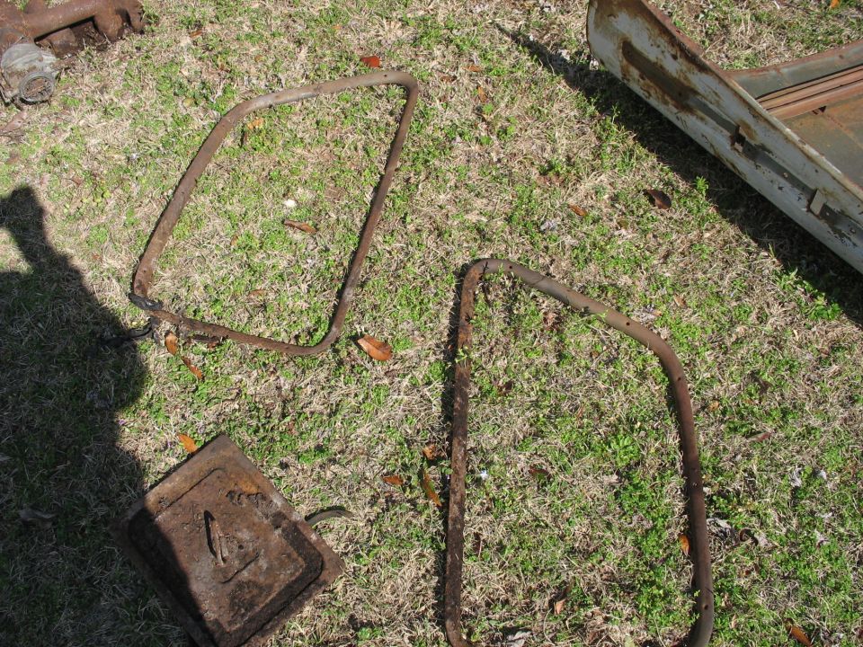 rusted door frames and a metal box on grass