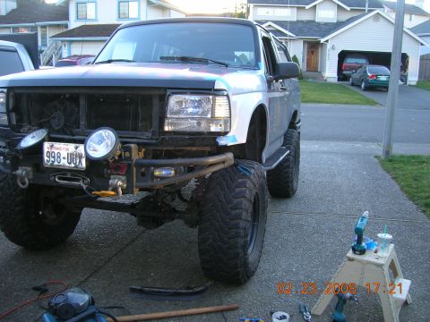 1996 Ford Bronco - This lifted truck features large off-road tires, a winch, and auxiliary lights on the front bumper.