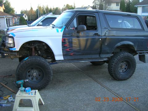 1996 Ford Bronco - Modified 1996 Ford Bronco with custom paint and large tires, parked outdoors.