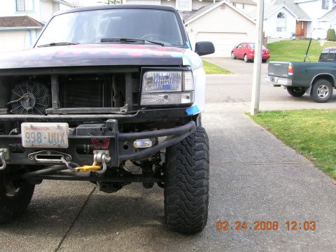 1996 Ford Bronco - The front of a modified 1992 Ford Bronco is visible, with a winch and custom bumper.