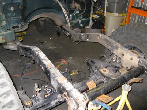 1994 Jeep YJ - Frame and suspension of a 1994 Jeep YJ are shown during a build or repair process.