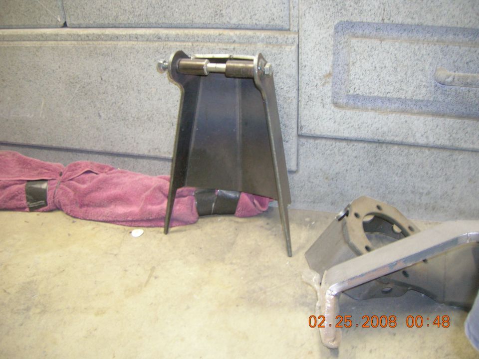 metal brackets on floor, one wrapped in a pink towel, with a date stamp of 02.25.2008