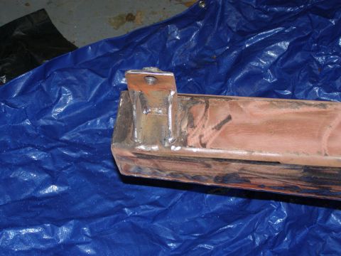 1993 Ford Bronco - Close-up of a metal rear bumper bracket, showing its mounting points and construction.