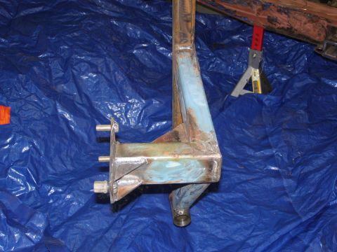1993 Ford Bronco - A close-up view of a rusted metal bracket, likely a vehicle part, resting on a blue tarp. The Supermotors.net logo is visible in the lower…