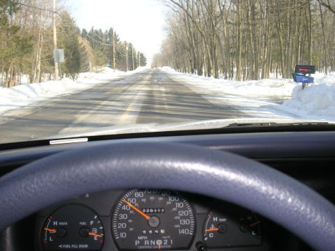 1997 Ford Crown Victoria - Driving through a winter landscape on a snow-covered road.