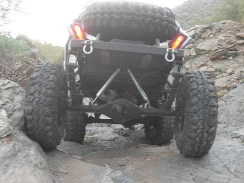 1986 Toyota Hilux - This heavily modified buggy navigates a challenging rocky trail, its off-road capabilities.