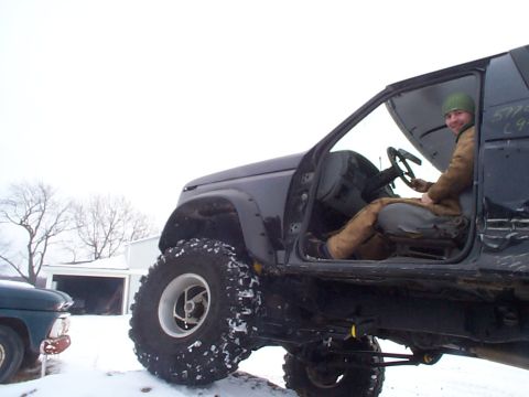 1981 Ford Bronco - Modified SUV interior with a driver, another vehicle in the background during winter.