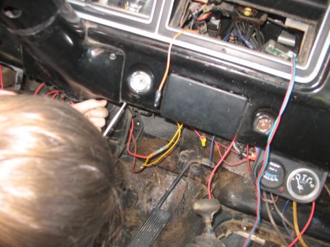 1978 Ford Bronco - Close-up of a vehicle's interior showing exposed wiring and gauges near the steering column.