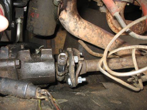1978 Ford Bronco - A socket wrench is attached to the universal joint of a vehicle's steering column.