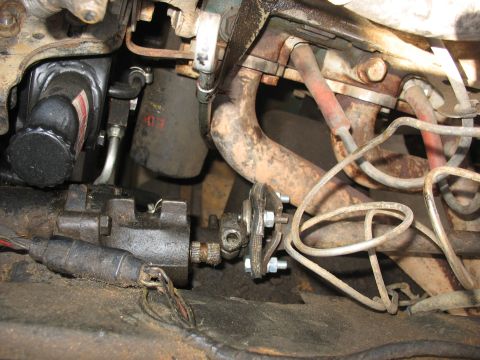 1978 Ford Bronco - Close-up view of steering column and engine components, including exhaust manifold and power steering pump.