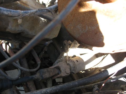 1978 Ford Bronco - Underside view of rusty steering column components, likely from an older vehicle.