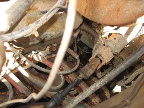 1978 Ford Bronco - This image shows a close-up view of the steering column and associated wiring, with visible rust and wear.