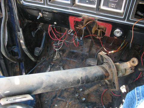 1978 Ford Bronco - Interior view of a 1978 Ford Bronco, highlighting the steering column and the complex wiring beneath the dashboard.