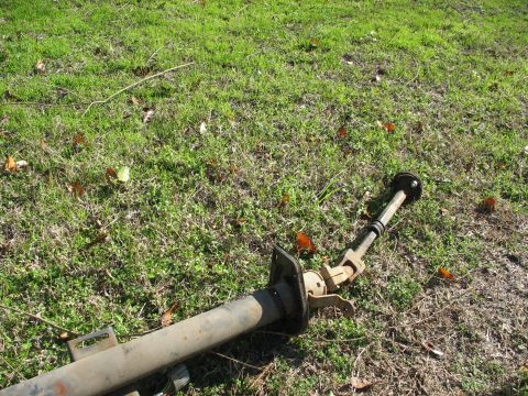 1978 Ford Bronco - A disassembled steering column lies on the ground, disconnected from any vehicle.
