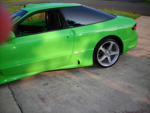 1994 Ford Probe - A bright green 1994 Ford Probe is shown from a three-quarter front angle, parked on a concrete surface.