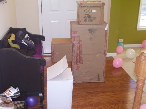 1979 Chevrolet Camaro - A collection of boxes and furniture are arranged in a room with balloons scattered on the floor.