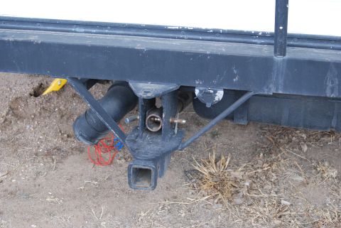 1987 Ford F-250 - Close-up view of a trailer hitch assembly with exposed plumbing and wiring, showing a connection point for towing.