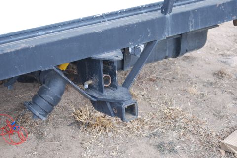 1987 Ford F-250 - Close-up of an RV's rear bumper assembly, showing the hitch receiver and waste pipe.