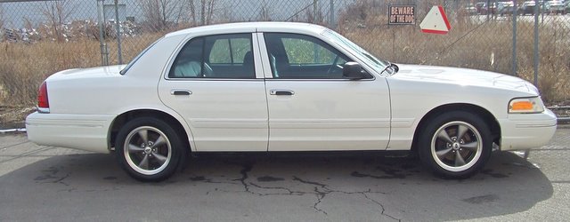 White 2004 Ford Crown Victoria sedan, side view