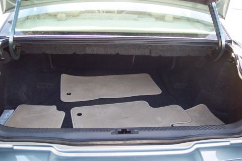 2001 Ford Crown Victoria - The interior of a car's trunk, showing floor mats and the carpeted lining.