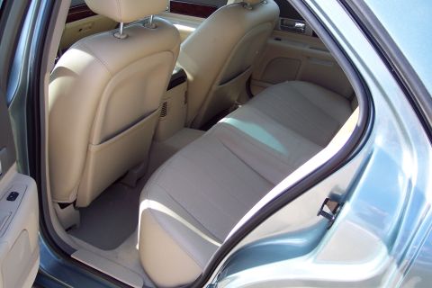 2001 Ford Crown Victoria - Interior view of the rear passenger area of a car, showing the seats and door panel.
