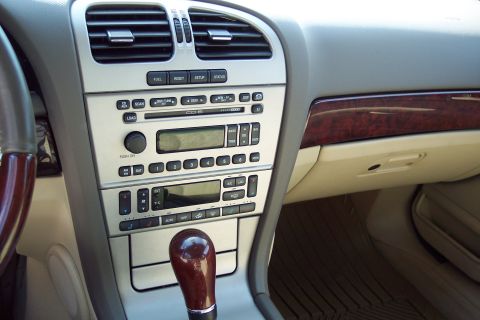 2001 Ford Crown Victoria - Interior view of a car's center console, the audio system and climate controls.