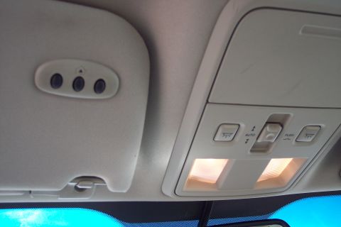 2001 Ford Crown Victoria - The interior overhead console features lights and controls, alongside a visor with garage door opener buttons.