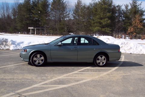 2001 Ford Crown Victoria - A gray 2006 Lincoln LS is parked in a lot with snow piles and trees visible.