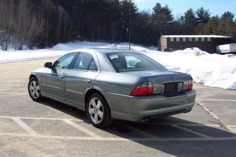 2001 Ford Crown Victoria - A green 2006 Lincoln LS sedan is parked in a lot with snow on the ground.