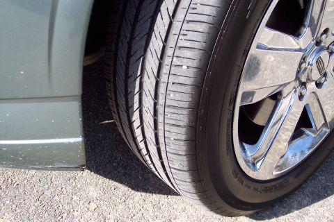 2001 Ford Crown Victoria - Close-up of a car tire and chrome wheel, showing the Lincoln logo on the center cap.