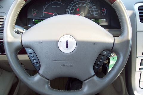 2001 Ford Crown Victoria - Interior view of a Lincoln vehicle's steering wheel and dashboard gauges.