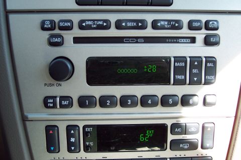 2001 Ford Crown Victoria - Close-up of a car's center console, showing the audio system and climate controls.