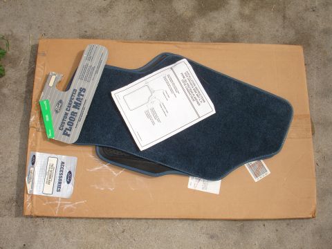 1993 Ford Taurus - Custom carpeted Ford floor mats are shown with their installation instructions on a cardboard box.