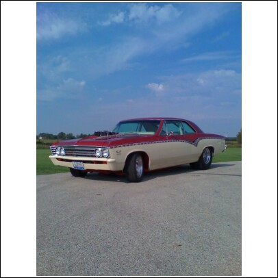 1967 Chevrolet Chevelle - This two-tone coupe has a prominent hood scoop and custom trim.