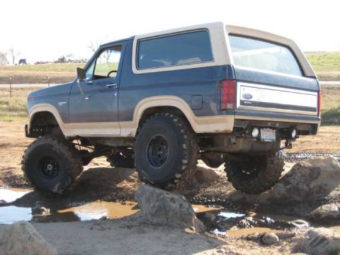 1978 Ford Bronco - This lifted Ford Bronco navigates a rocky, muddy terrain.