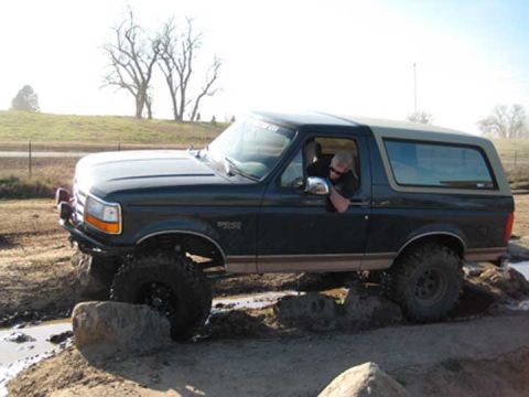 1978 Ford Bronco - A Ford Bronco navigates an off-road obstacle course with a driver behind the wheel.
