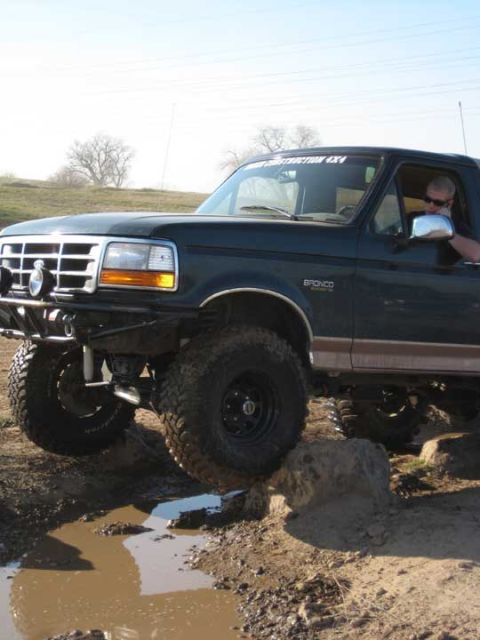 1978 Ford Bronco - This Ford Bronco is shown off-roading through a muddy obstacle course.