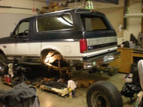 1993 Ford Bronco - 1993 Ford Bronco undergoing modifications in a workshop setting.