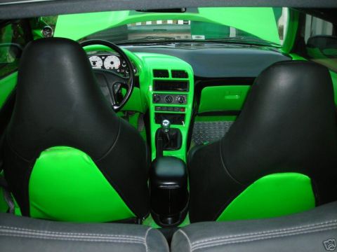 1994 Ford Probe - The interior of a car features custom bright green upholstery and trim, contrasting with black seats and dashboard elements.