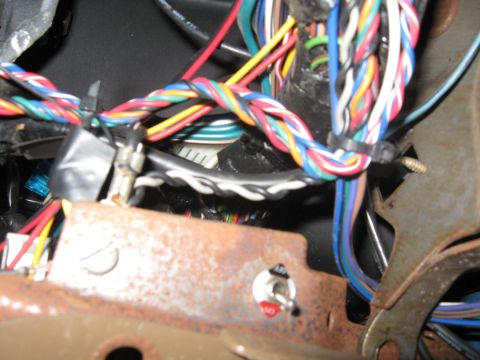 1990 Ford Bronco - Wiring harness and a toggle switch are visible in this close-up view of a vehicle's interior components.