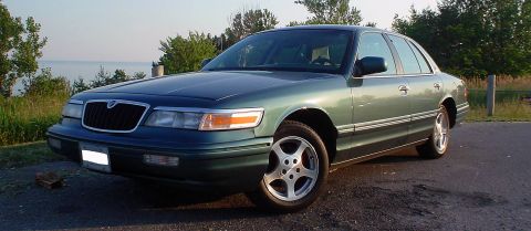 1996 Mercury Grand Marquis - A 1996 Mercury Grand Marquis is parked outdoors near a body of water.