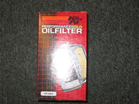 1995 Ford Thunderbird - Box for a K&N Performance Gold Oil Filter, model HP-2009, is displayed on a textured surface.