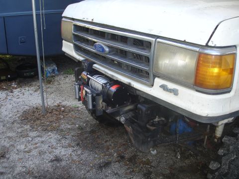 1989 Ford Bronco - This Ford truck features a winch mounted to its front bumper, with 4x4 badging visible.