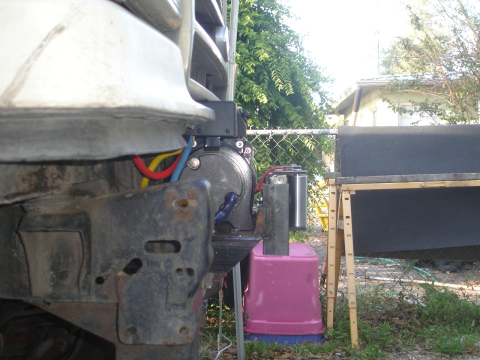Winch mount with red, yellow, and blue wires attached to a vehicle's front end